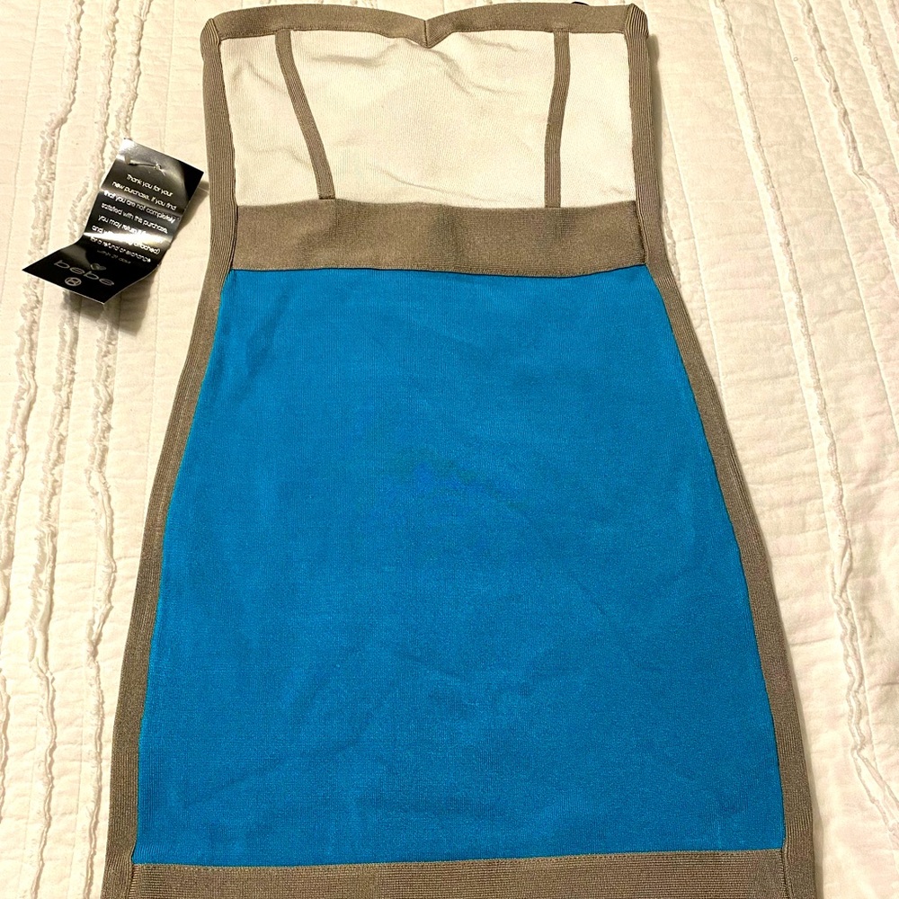 Bebe form fitting mini dress size medium. Turquoise with taupe and white accents